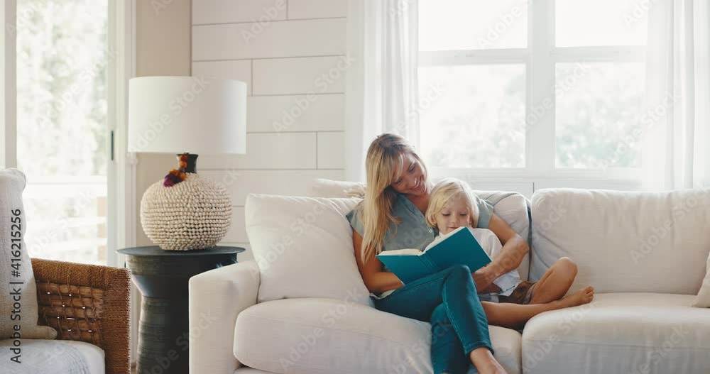 Young mother and son reading together at home on the couch, quality family time, teachable moments, family lifestyle Young mother and son reading together at home on the couch, quality family time, teachable moments, family lifestyle