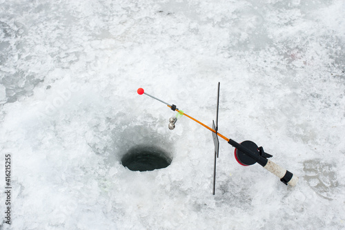 Ice fishing hole, fishing rod
