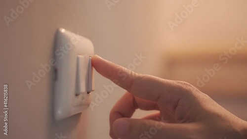 4K Close up hand push switch on-off electric light. Concept of energy and power saving.