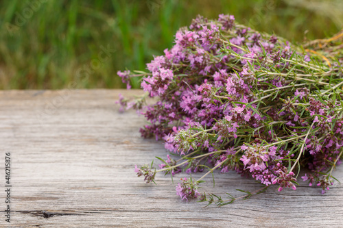 Thyme flowers on wooden boards and natural background.