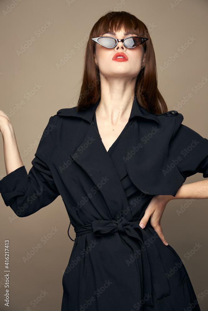 Sexy woman Shows with his hand to the side black coat beige Sexy woman Shows with his hand to the side black coat beige
