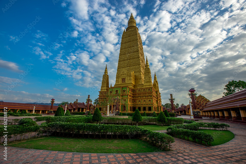 Fototapeta premium Wat Mahathat Wachiramongkol Former name (Wat Bang Tong) is located Krabi,The environment is rubber plantation. And oil palm plantation, a towering pagoda is beautiful, tourists are always watching.