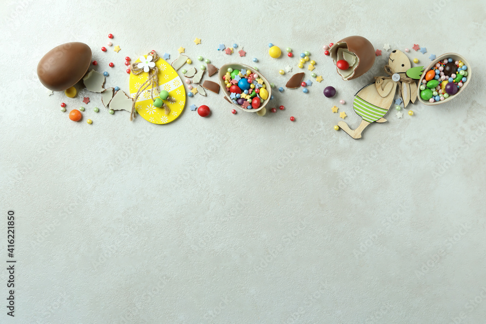 Obraz premium Easter concept with chocolate eggs on white textured background