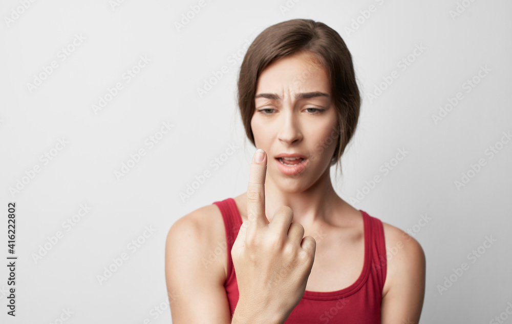woman with broken finger in red t-shirt injury health problems woman with broken finger in red t-shirt injury health problems