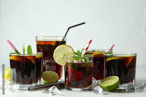 Photography Glasses of Cuba Libre on white textured table