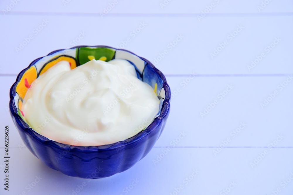 Greek yogurt in a bowl. White background
Greek yogurt in a bowl. White background
