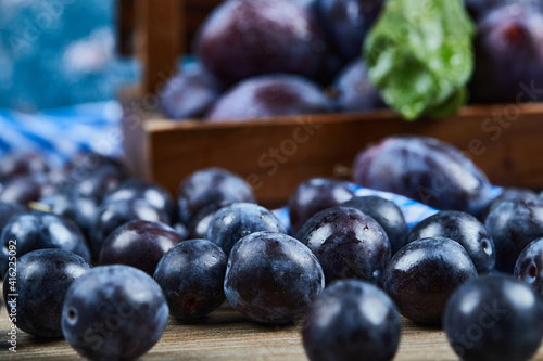 Wallpaper Mural Garden plums scattered through wooden table Torontodigital.ca