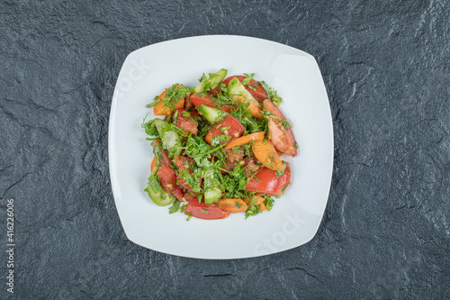 A white plate of delicious vegetable salad