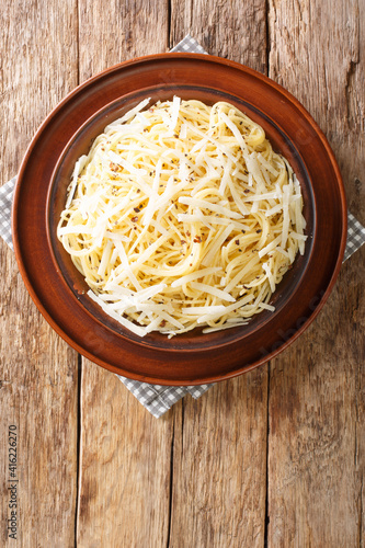 Spaghetti Cacio e Pepe Recipe closeup in the plate on the table. Vertical top view above