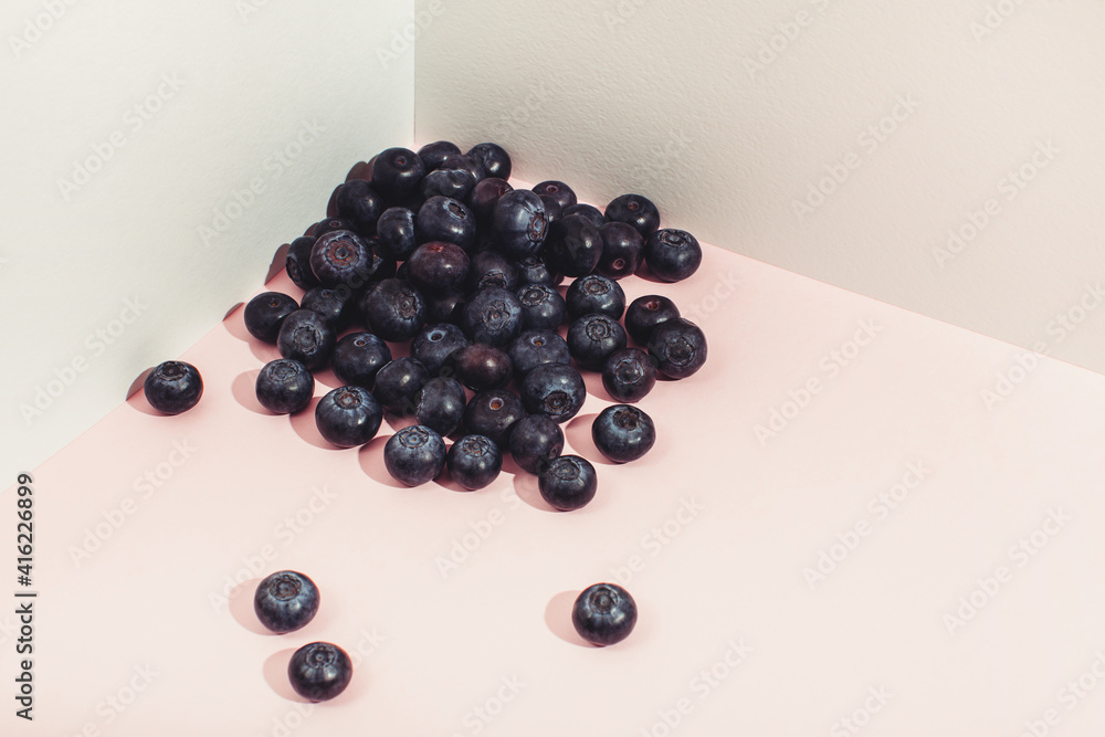 A pile of blueberries is scattered in the corner. Modern still life composition. A pile of blueberries is scattered in the corner. Modern still life composition.