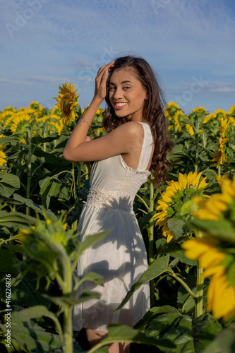 Summer look. Beautiful girl in sunflower fields. © Adriana Nikolova