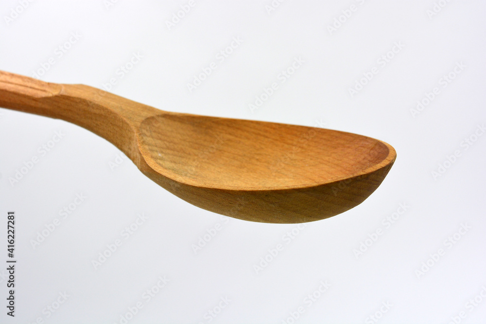 Products made of natural handmade tree. Wooden big spoon with carvings. Beautiful and unusual things on a white background. Products made of natural handmade tree. Wooden big spoon with carvings. Beautiful and unusual things on a white background.