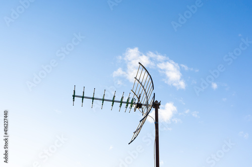 View of a tv antenna with the blue sky in the background