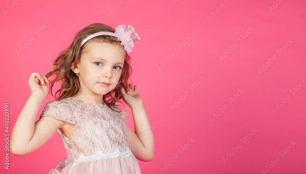 Portrait 5-6 year old girl in dress on pink isolated background looks at camera. Concept Playing and Children Recreation. Little child in casual clothes posing and showing emotions. Copy space