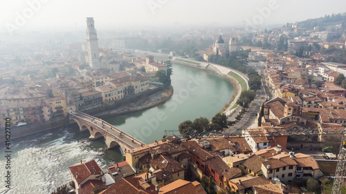 Obraz na płótnie Aerial view of Verona crossed by the Adige river and shrouded in winter fog. w salonie