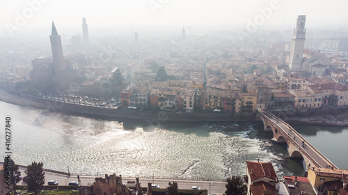 Obraz na płótnie Aerial view of Verona crossed by the Adige river and shrouded in winter fog. w salonie