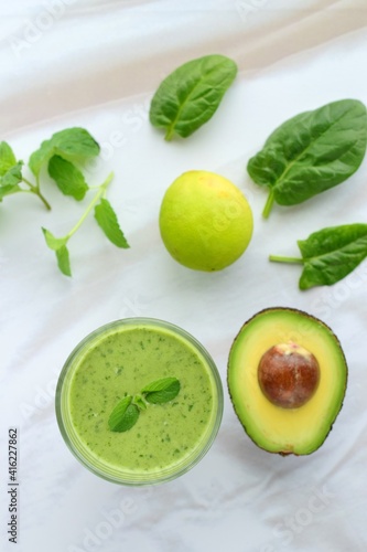 Green smoothie made from spinach , banana, avocado, soy milk and lime juice