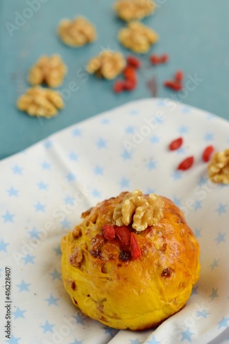 Homemade healthy delicious bread buns with walnut and goji berry. Selective focus, blurred background