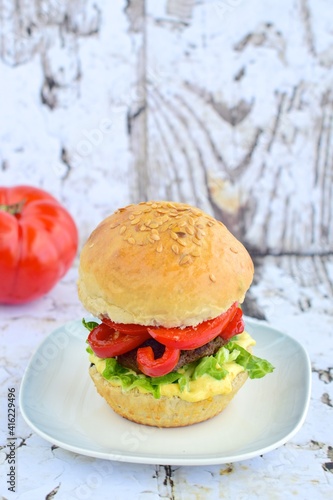 Beef burger with red bell pepper, lettuce and mustard mayonnaise sauce