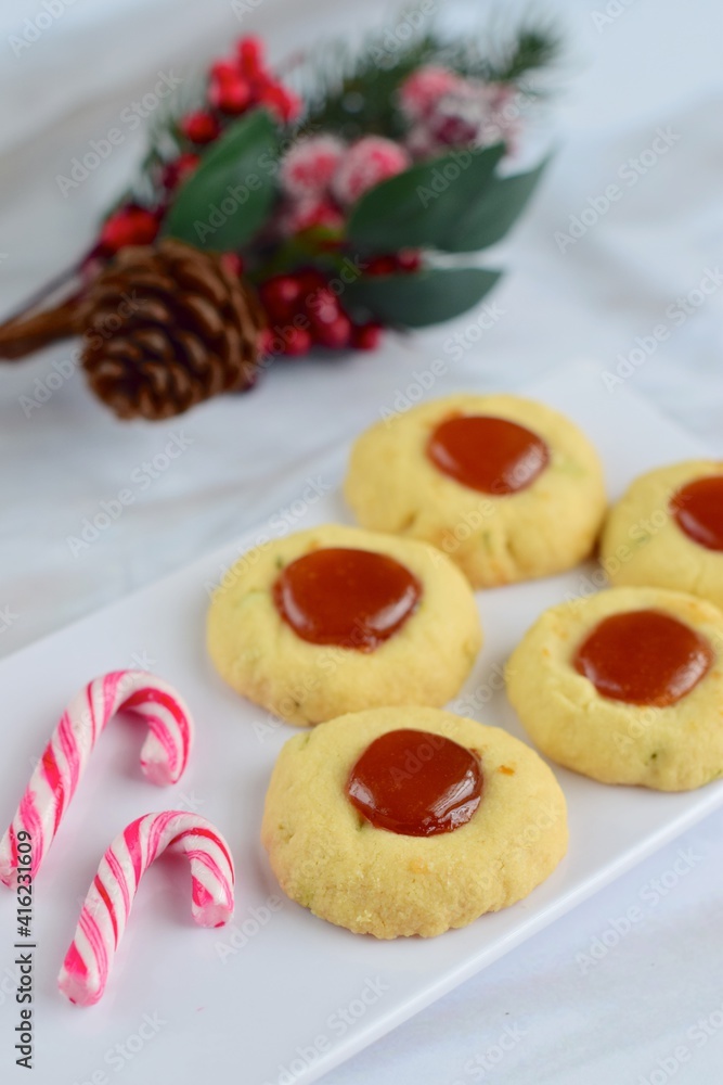 Thumbprint cookies on white background with Christmas decoration
Thumbprint cookies on white background with Christmas decoration