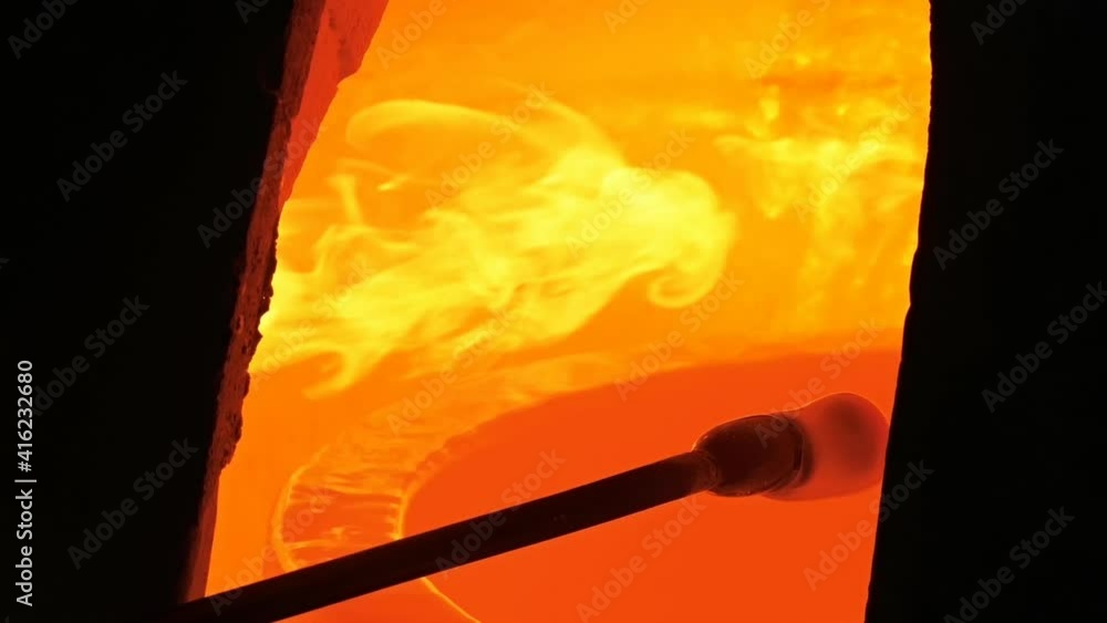 Traditional glass blower manufacturing process, working on a bubble of
