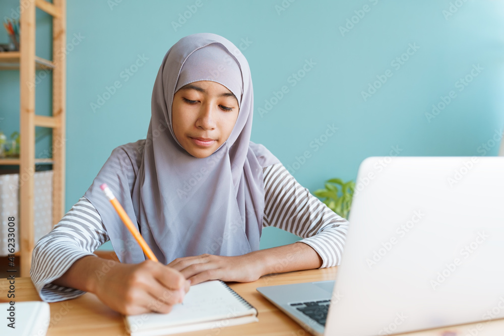 Muslim girl learning online via the internet tutor on a laptop computer at home
Muslim girl learning online via the internet tutor on a laptop computer at home