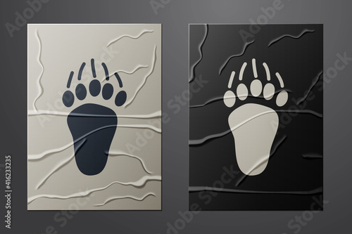 White Bear paw footprint icon isolated on crumpled paper background. Paper art style. Vector.