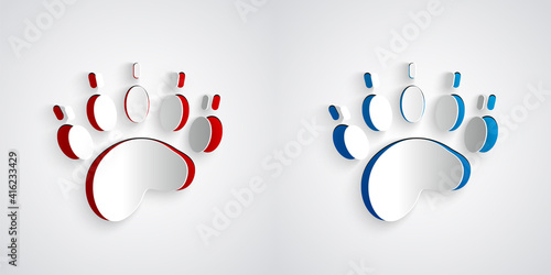 Paper cut Bear paw footprint icon isolated on grey background. Paper art style. Vector.