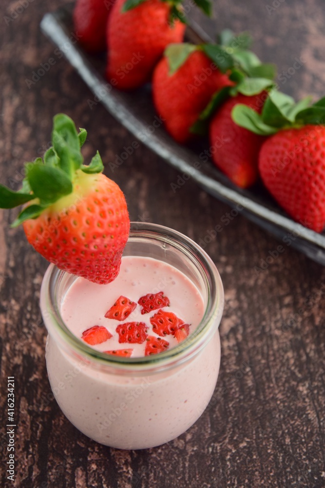 Fresh organic strawberry smoothie in a jar on wooden background Fresh organic strawberry smoothie in a jar on wooden background