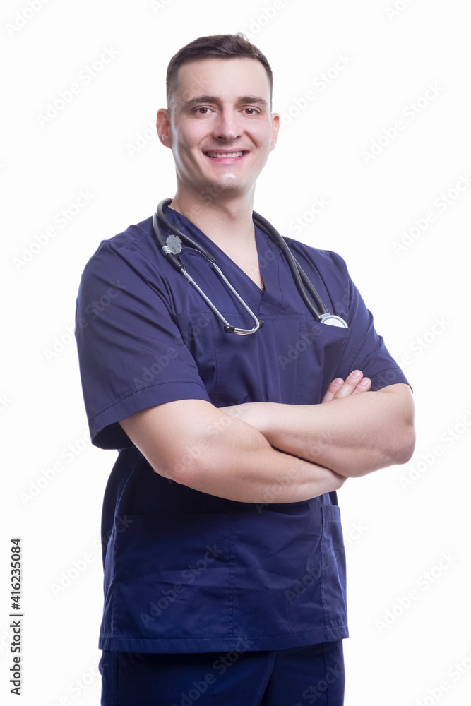 Medical Ideas. Portrait of Smiling Professional GP Doctor Posing in Blue Doctor's Smock With Endoscope and Hands Folded in Front on White Medical Ideas. Portrait of Smiling Professional GP Doctor Posing in Blue Doctor's Smock With Endoscope and Hands Folded in Front on White
