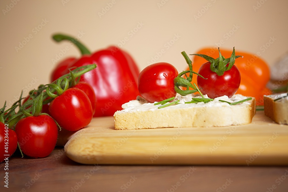 toast bread with tomato and pepper spread and chives on a wooden board toast bread with tomato and pepper spread and chives on a wooden board