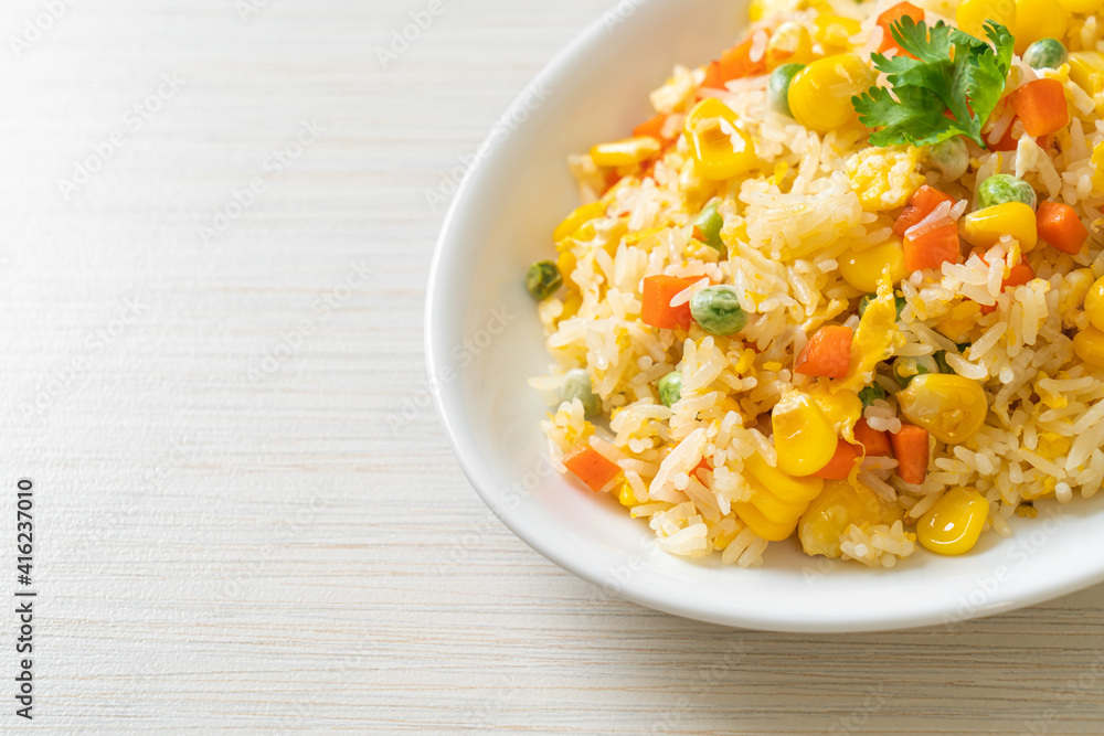 fried rice with mixed vegetable (carrot, green bean peas, corn) and egg fried rice with mixed vegetable (carrot, green bean peas, corn) and egg