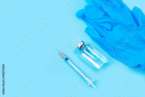 Vaccines and syringes  face mask on blue background.