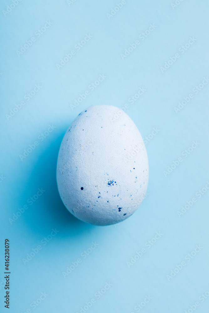 Blue chocolate easter egg. Sweet candy egg on blue background.