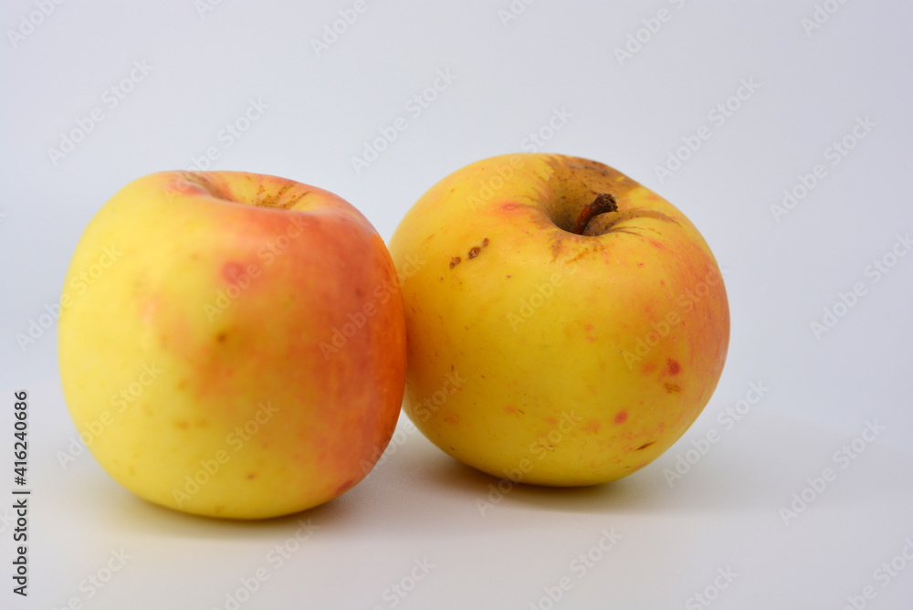 Small ripe yellow apples with red sideways located on a white background. Small ripe yellow apples with red sideways located on a white background.