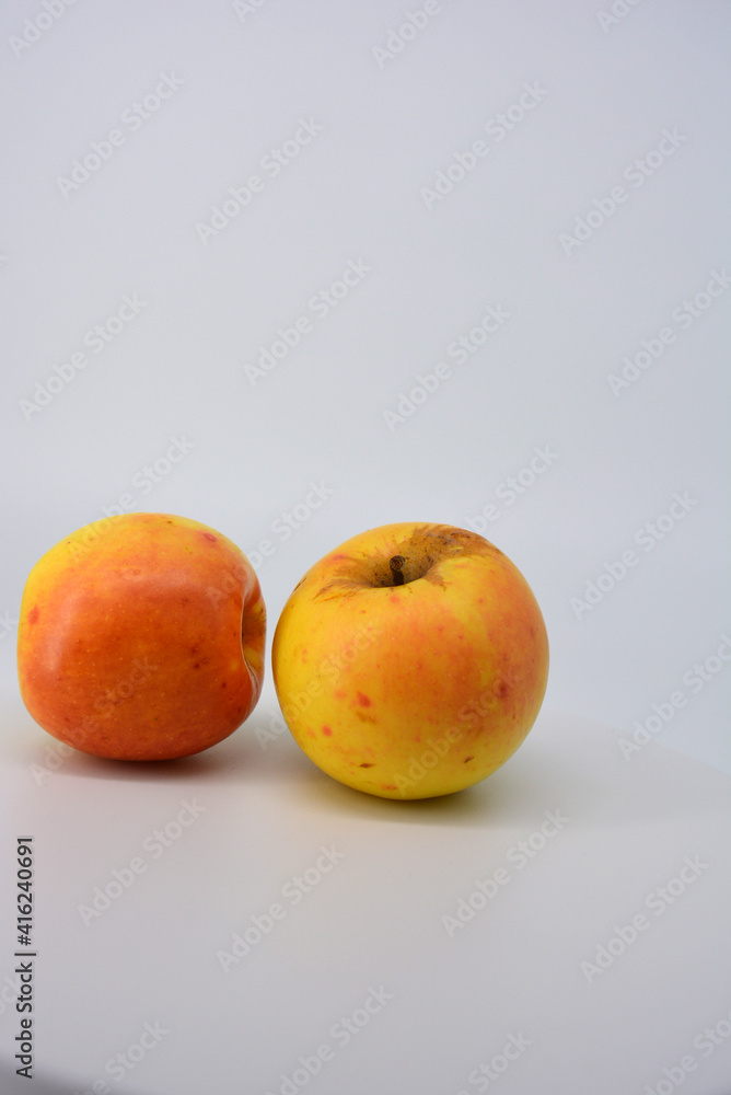 Small ripe yellow apples with red sideways located on a white background. 
