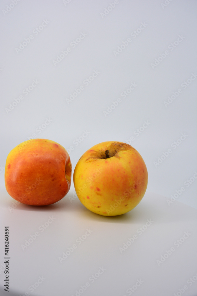 Small ripe yellow apples with red sideways located on a white background. Small ripe yellow apples with red sideways located on a white background.