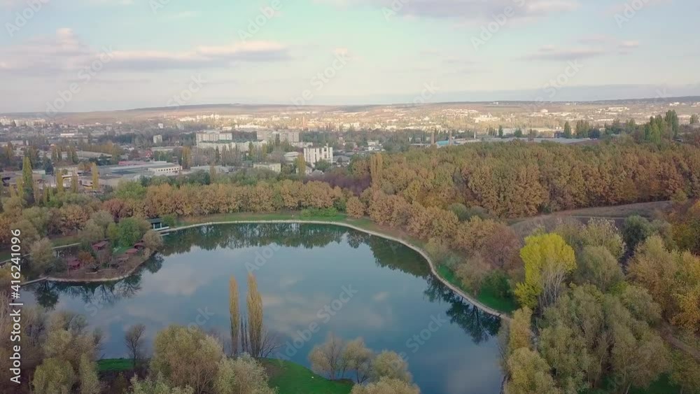 Aerial view with drone over a city, House located in the middle of the park. Beautifully protected lake. The city of Chisinau seen from above. Beautiful autumn landscape. Aerial view with drone over a city, House located in the middle of the park. Beautifully protected lake. The city of Chisinau seen from above. Beautiful autumn landscape.