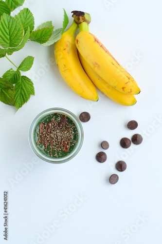 Spirulina mint banana smoothie with chocolate and chia seeds. White background