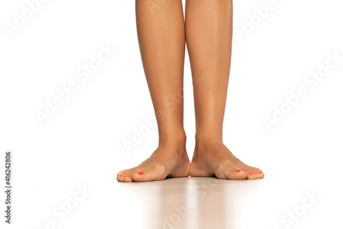 Female legs and feet isolated on white. © Jasmina