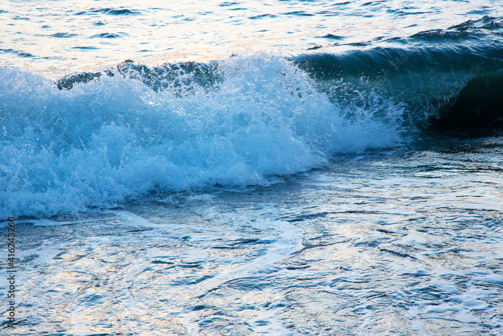 frothy white waves on the sandy beach of the Baltic Sea. Blue sea and bright blue sky, high tide frothy white waves on the sandy beach of the Baltic Sea. Blue sea and bright blue sky, high tide
