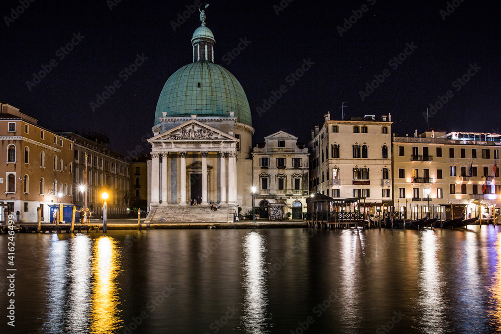 Venice night view of the church of San Simeon Piccolo on the Grand Canal with the night lights reflecting in the water 
