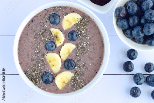 Acai berry smoothie bowl with banana, blueberry and chia seeds.  Top view