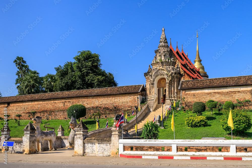 Fototapeta premium Gate and staircase to Wat Phra That Lampang Luang temple, famous tourist destination, Lampang province, Thailand