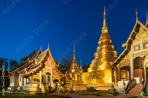 Chapel and golden pagoda at Wat Phra Singh Woramahawihan in Chiang Mai at twilight or night with stars in sky © wirojsid