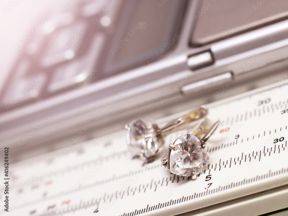 Silver earrings on a measuring instrument in a pawnshop Silver earrings on a measuring instrument in a pawnshop
