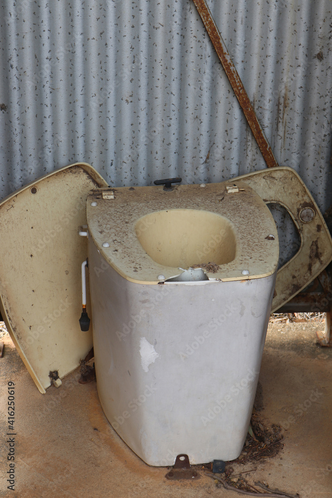 broken dirty unused outdoor toilet in tin shed broken dirty unused outdoor toilet in tin shed