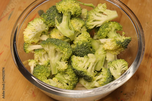 Broccoli into a bowl isolated in wood background