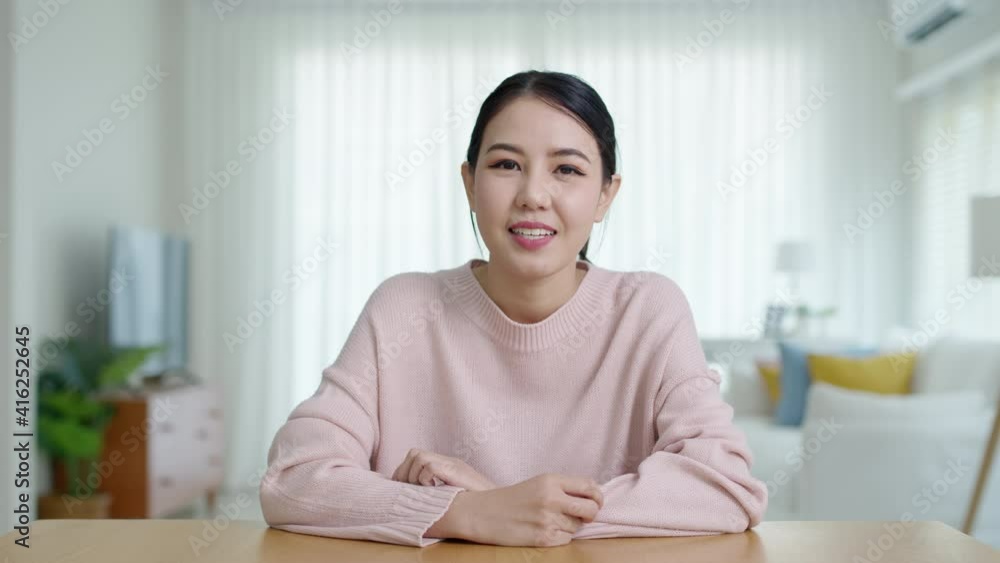 Portrait confident asia creative female vlogger make live talk video conference call, chat online on computer and sitting on table at home, Webcam view, video chat camera and Self isolation concept. Portrait confident asia creative female vlogger make live talk video conference call, chat online on computer and sitting on table at home, Webcam view, video chat camera and Self isolation concept.