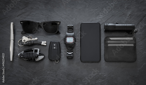 Set of EDC (Every Day Carry) items on dark background photo
